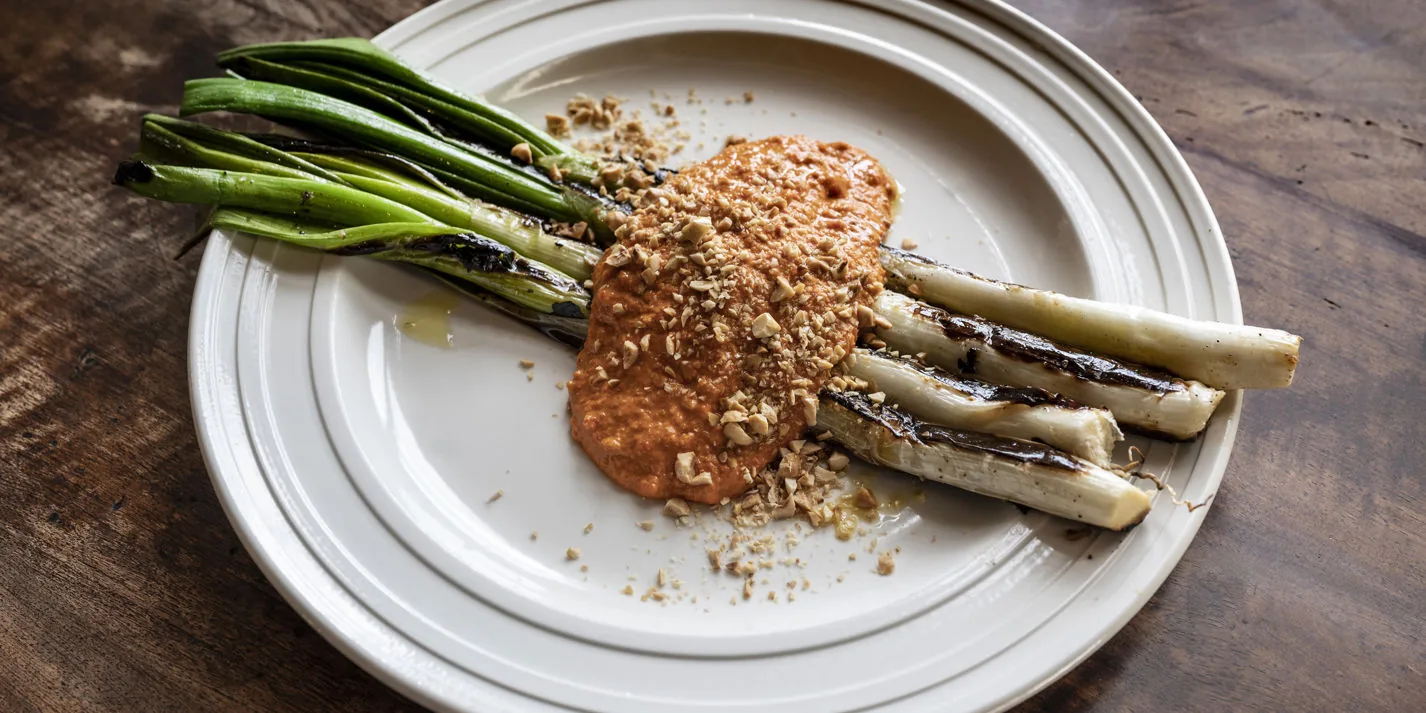 Calçots with romesco sauce - charred spring onions, Catalan tradition (Tarragona, Spain)